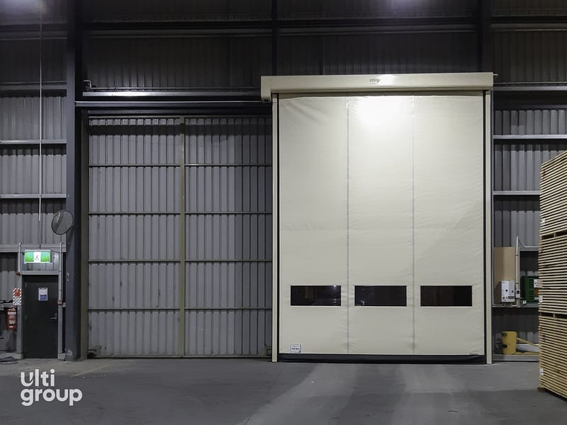 Ulti Roll high speed door installed in a warehouse next to a sliding door.